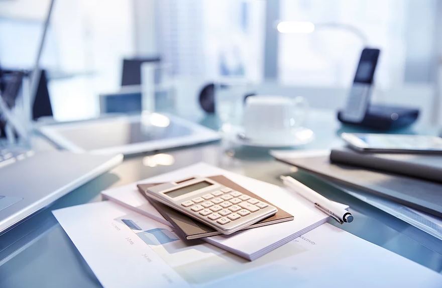 Photo os Calculator and documents on a meeting table