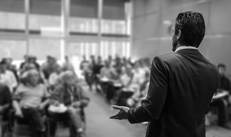 Men talking to a group of people